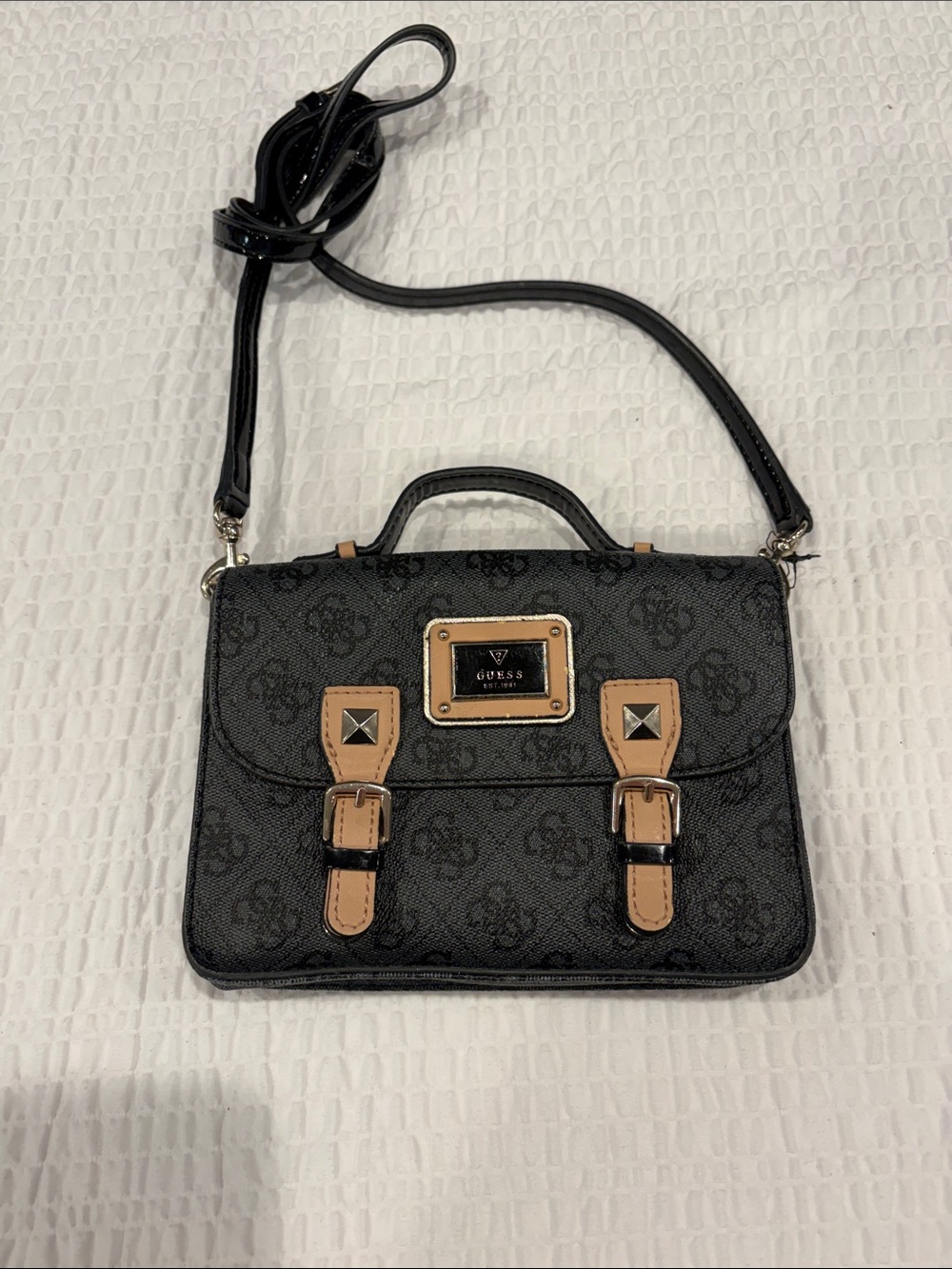 GUESS Black Crossbody Satchel with Tan Accent Straps and Gold Plaque